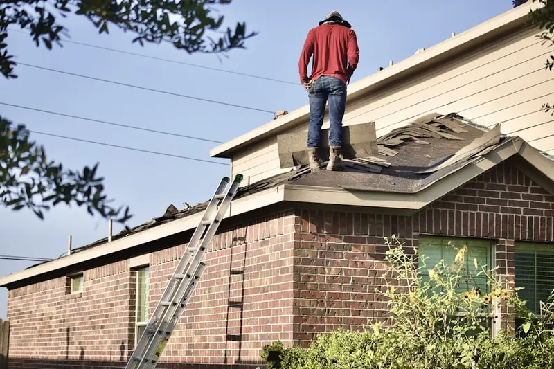 Professional roofer working on a residential roof in Wilde Lake